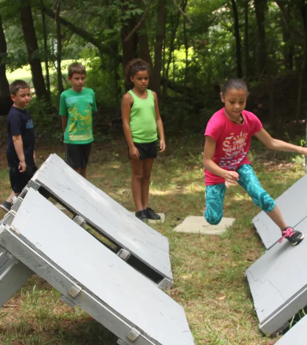 Kids bouncing on side tramps